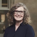 Sara Shaw profile pic wearing dark top and glasses