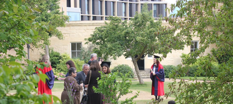 New graduates have their photographs taken in the gardens outside the Radcliffe Observatory at Green Templeton College.