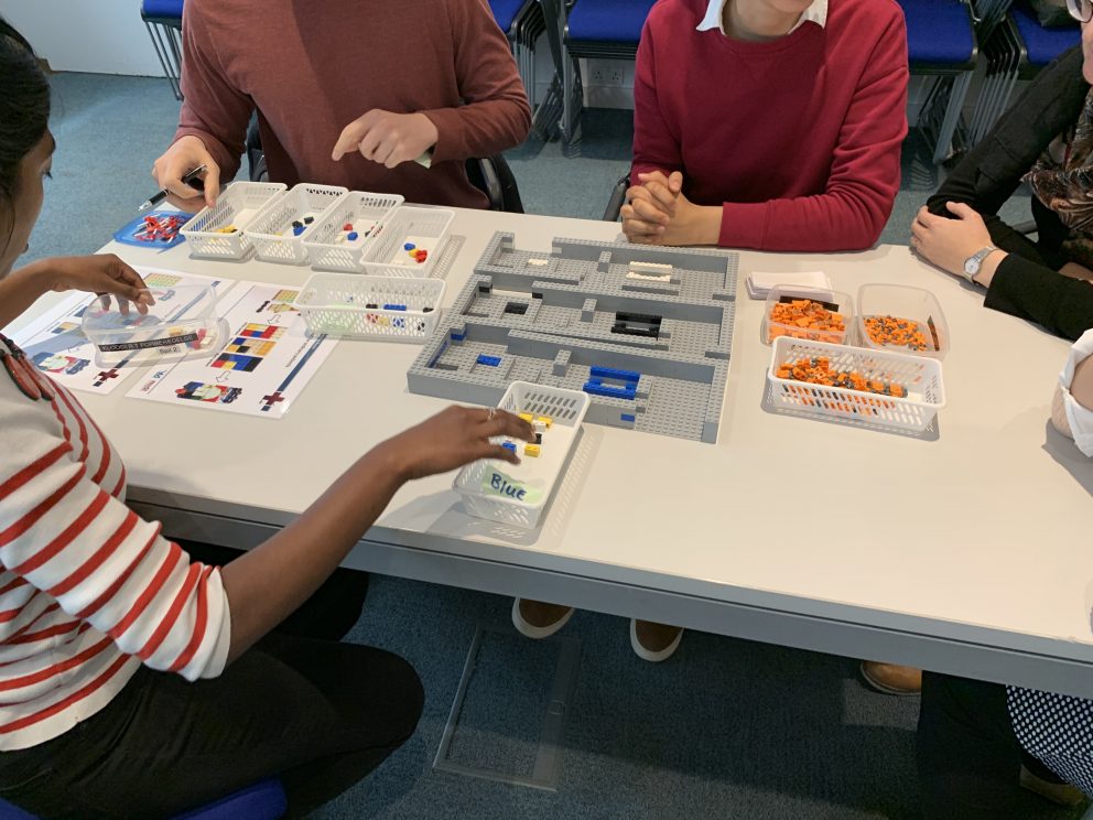 Participants using LEGO during a Management in Medicine, BRICK HOSPITAL workshop in May 2019