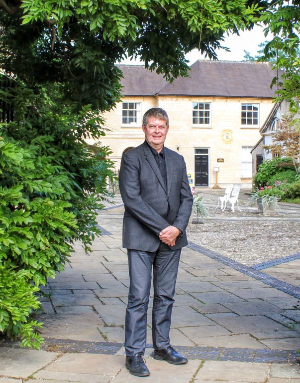 Sir Michael Dixon in college grounds