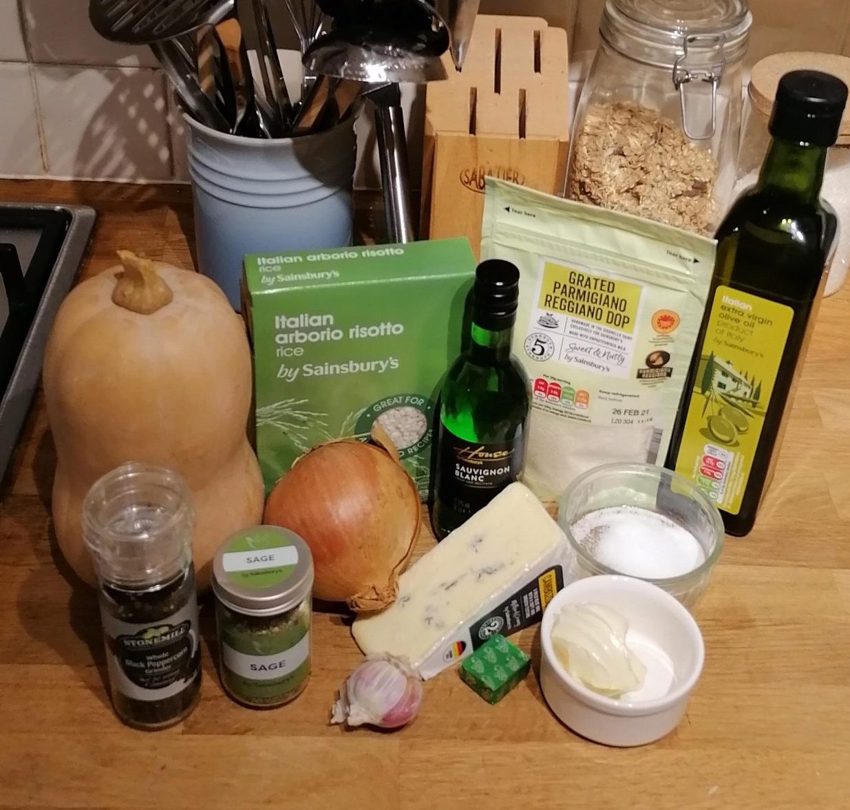 The ingredients required to make roasted butternut squash risotto lined up on a kitchen counter ahead of cooking