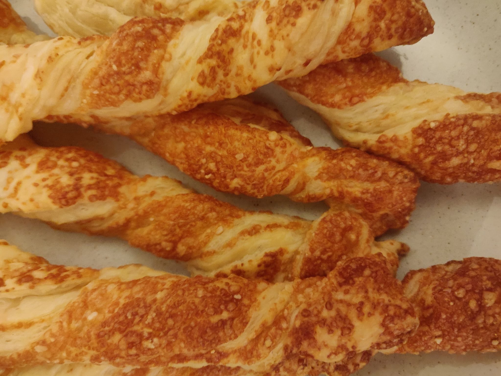 Freshly baked soft cheese straws with a golden brown and crispy finish