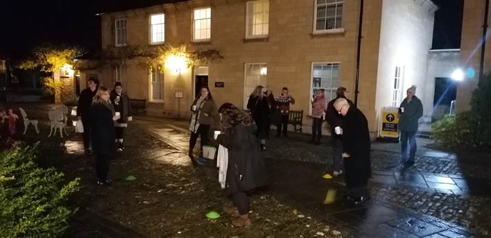 Staff members mark the end of Michaelmas 2020 with mulled wine and minced pies in the Quad at a social distance from each other