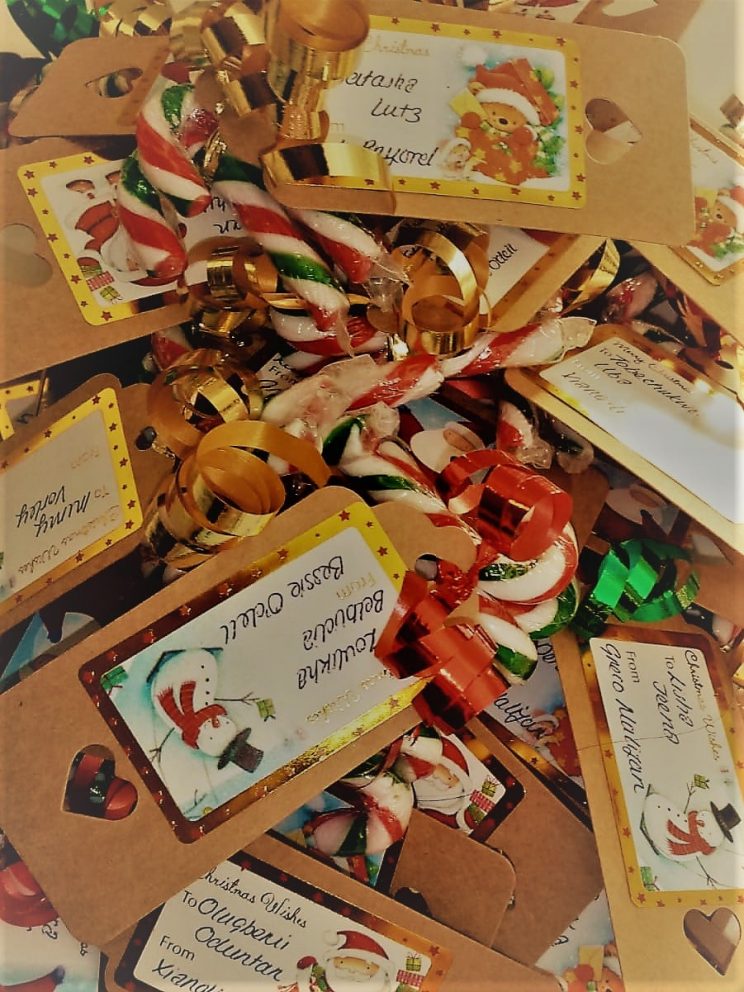 A pile of candy canes containing personalised labels for various students