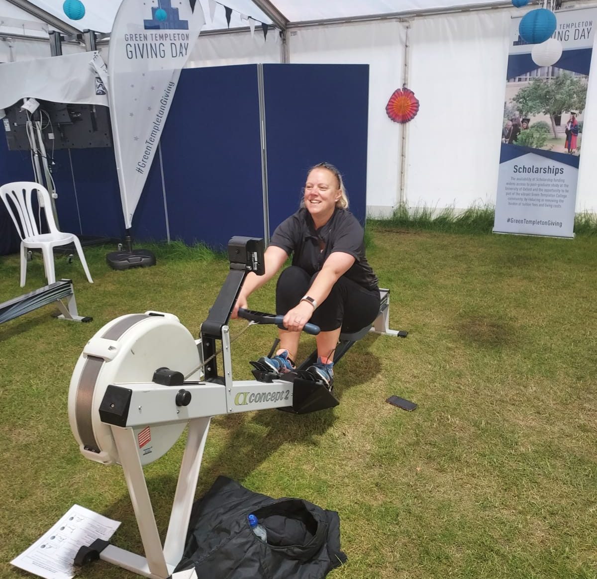 Operations Manager Elaine Huckson on the rowing machine in the college marquee