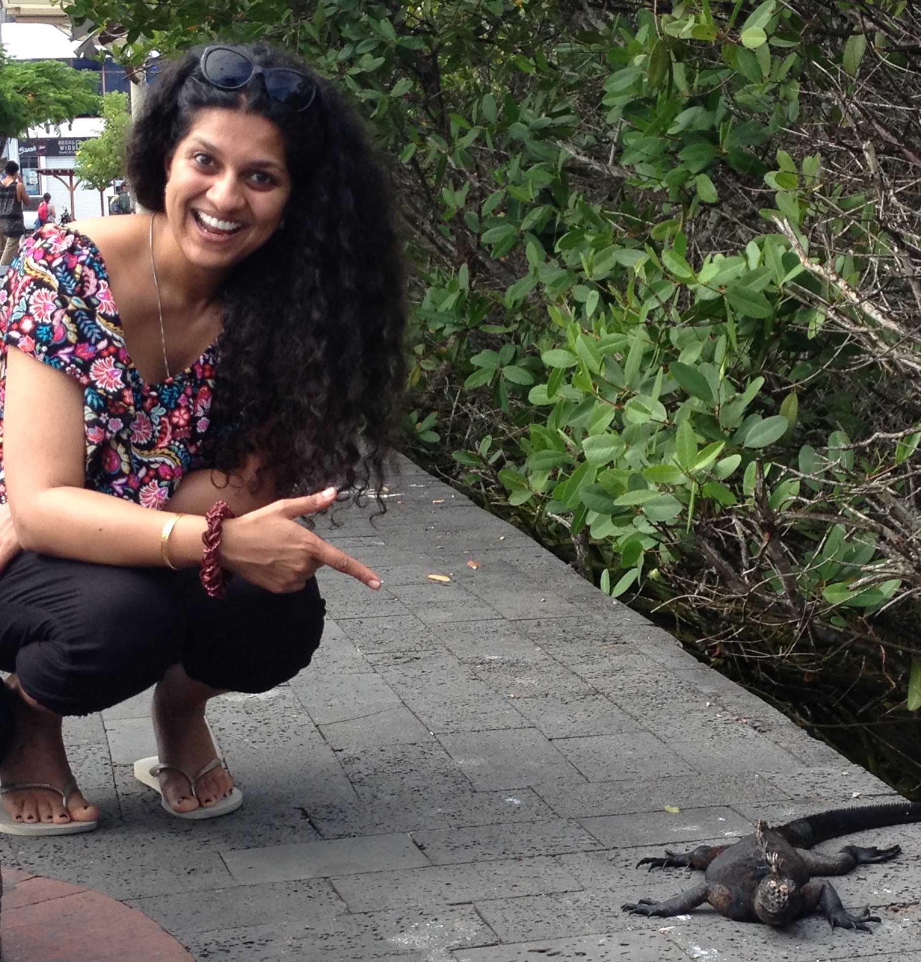 Dr Sai Pathmanathan smiles as she points to a lizard on the street 