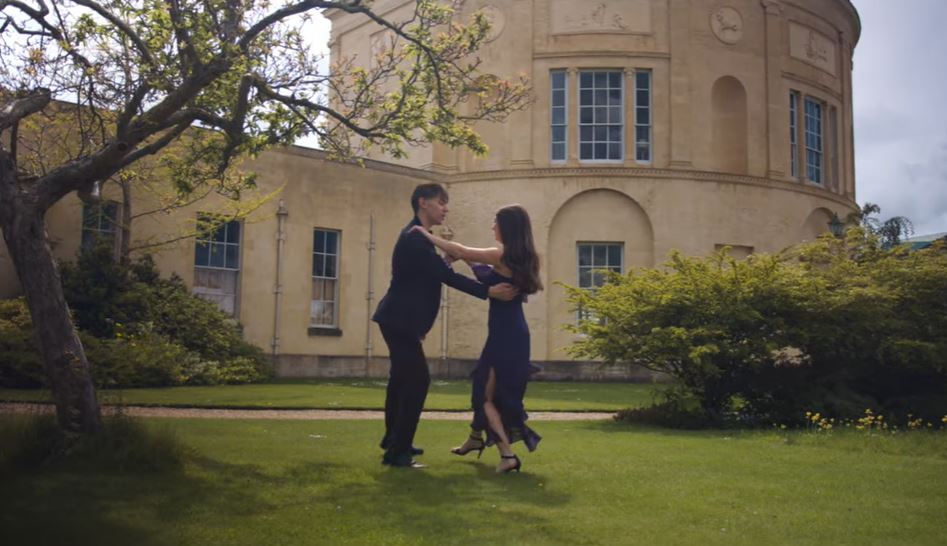 Sarah Brand dancing with a male partner in front of the Radcliffe Observatory