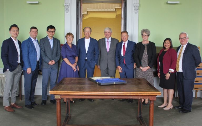 John Webster alongside college members and visitors in the doorway of the Radcliffe Observatory Common Room