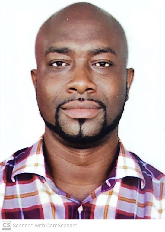 Makafui Tunde Adebayo, facing the camera directly wearing a checked shirt