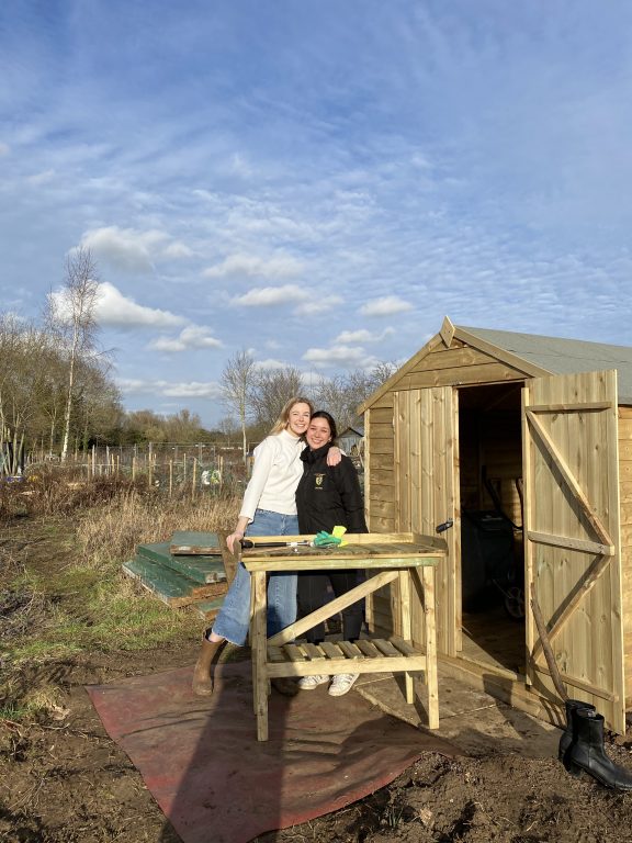 Allotment club members standing in front of new shed