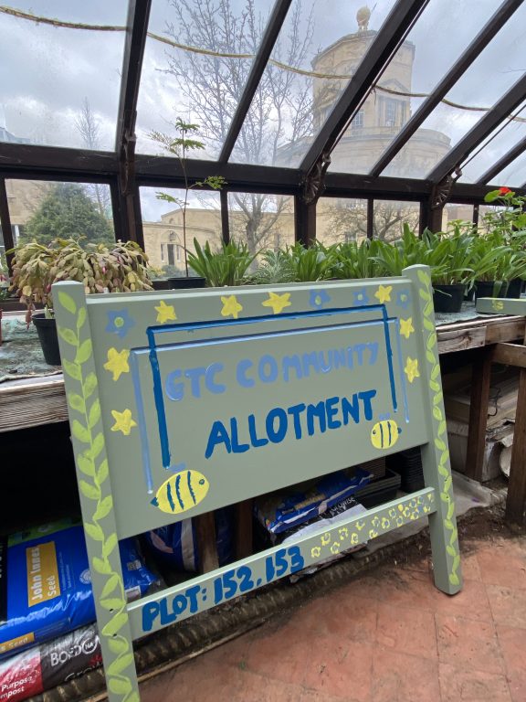 Allotment club sign drying in the green house