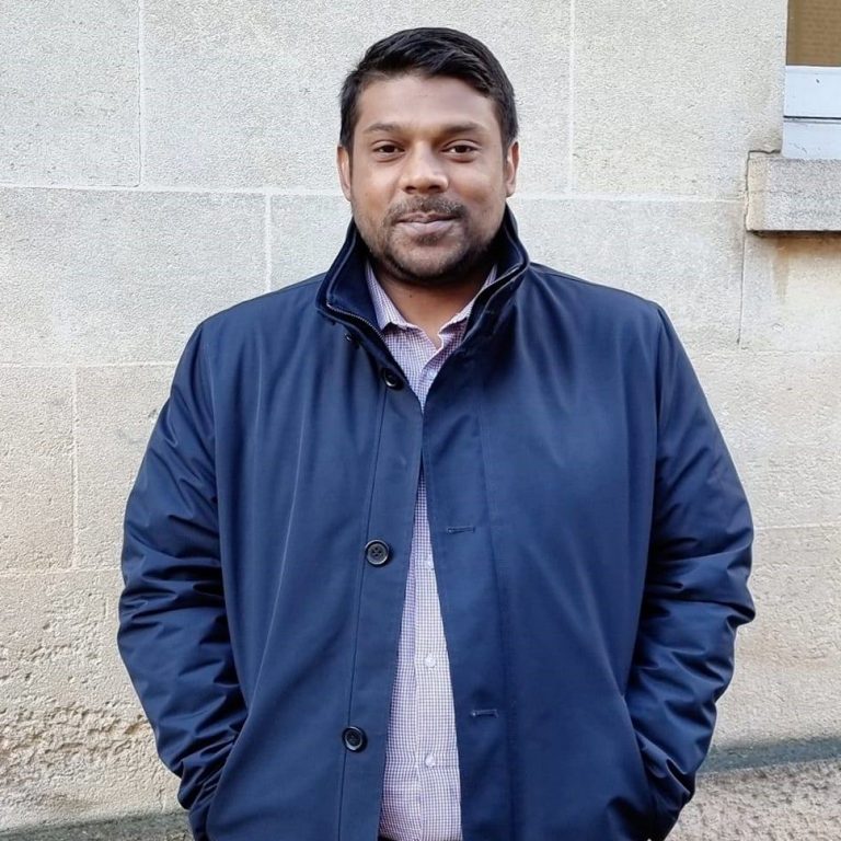 Shah Ali Farhad wearing a navy