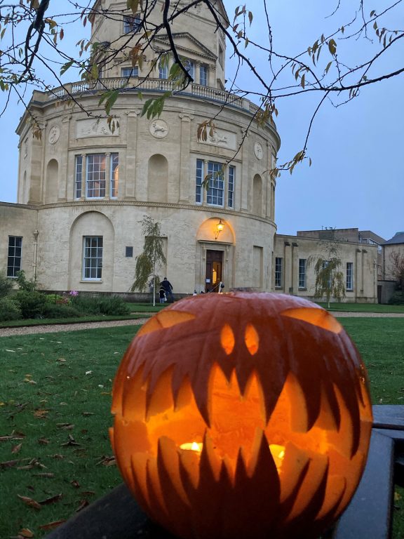 Pumpkin lit up in garden with Radcliffe Observatory behind