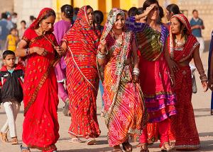 Young women walk together chatting in the street