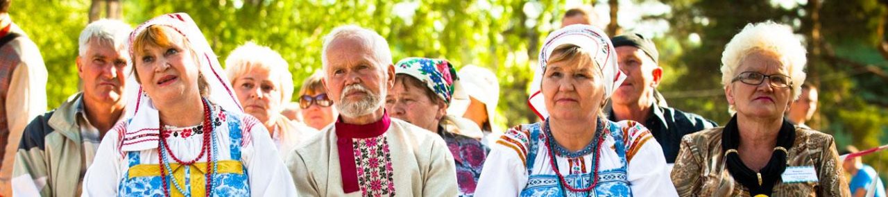 A group of men and women sit outdoors as they attend an event