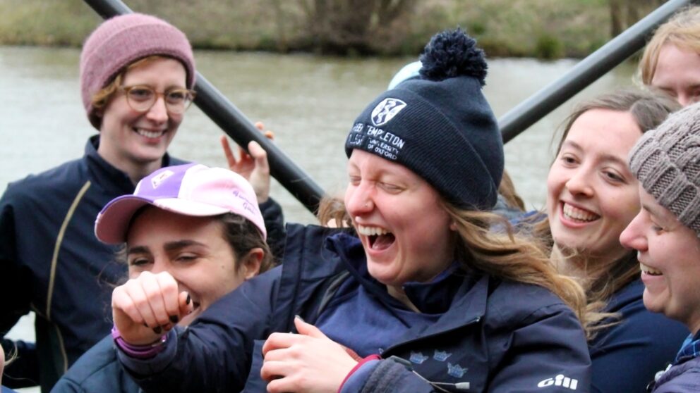 Celebrating Boat Club Members By The River with oars behind