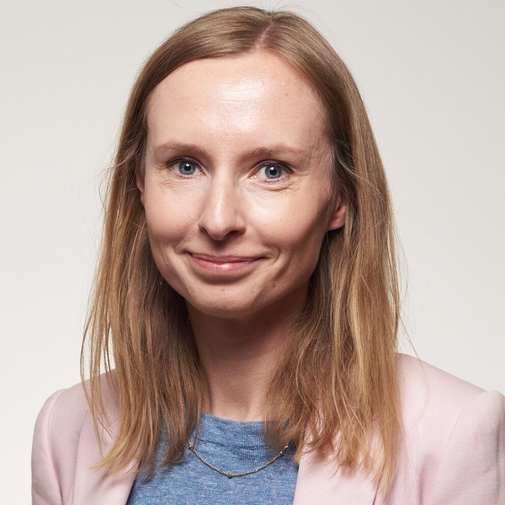 Marta Wanat Profile Picture in blue top and pink jacket