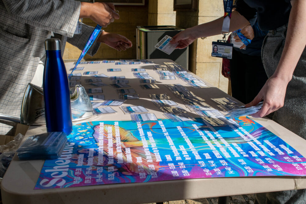 Registration desk with badges laid out and being handed out