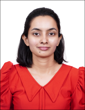 Rasika Bombatkar in front of white background wearing red dress