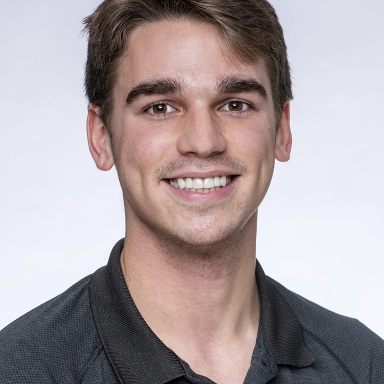 Craig Decker wearing black polo shirt