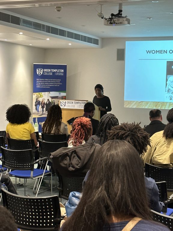 Isatou M. Bokum giving talk in front of audience for Black History Month