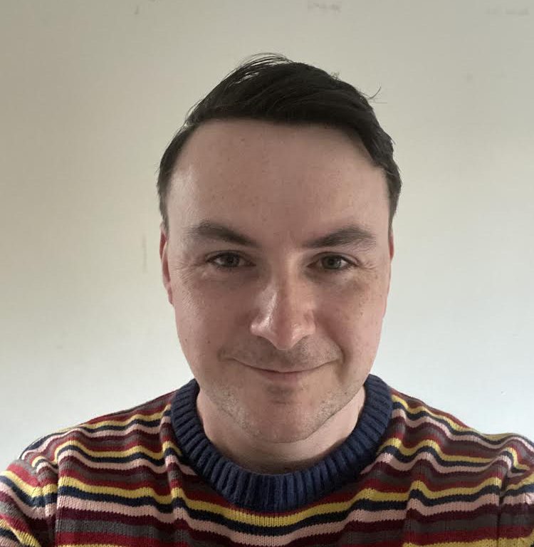 Daniel North headshot wearing stripped jumper