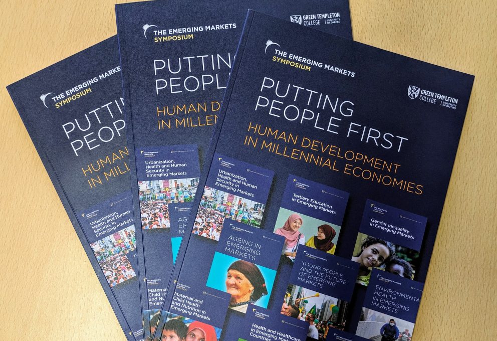 Three Putting People First Mongraphs On A Desk