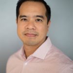 Thang Vo Ta Grey Headshot in front of light grey background