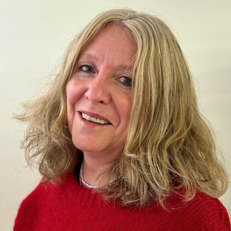 Ingeborg Rangul wearing red jumper in front of cream background