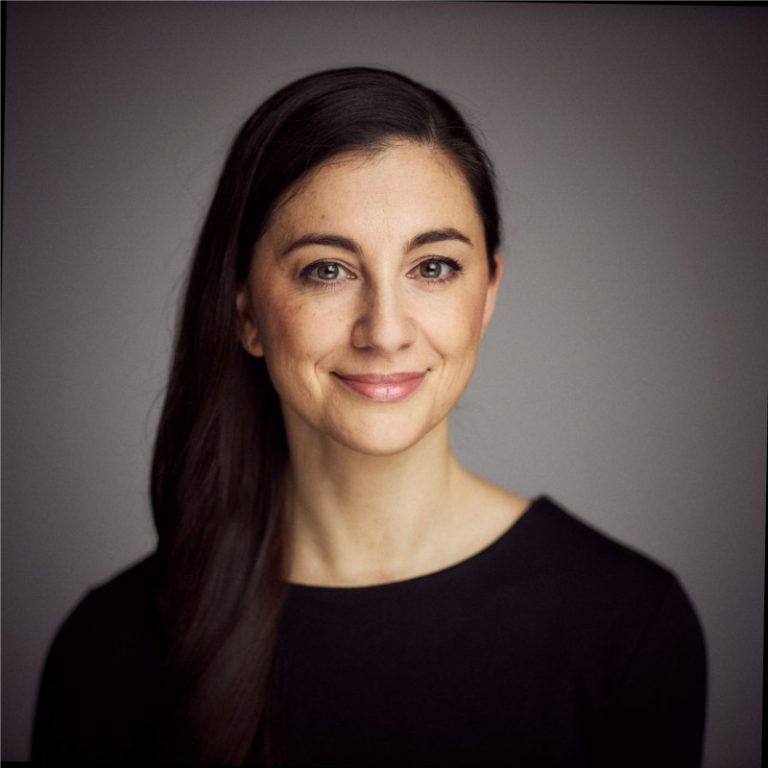 Christiane Hagel wearing black top in front of grey background