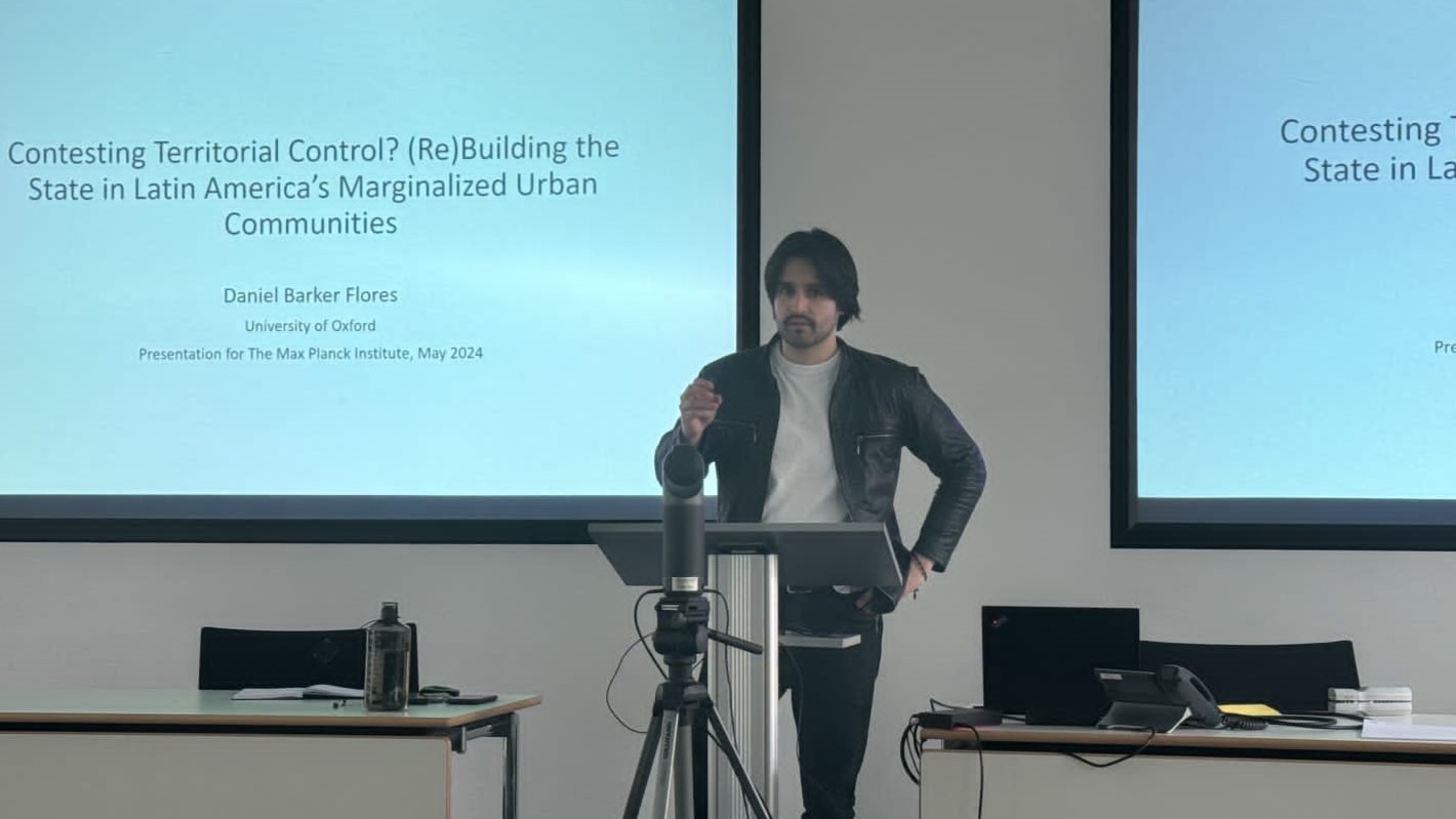 Daniel Barker Flores Standing Giving Lecture 16 X 9