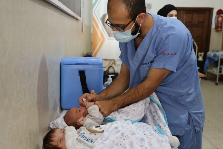 Nurse Giving Twins( Sayf And Yousf Sharyan) Polio Vaccine In Pa