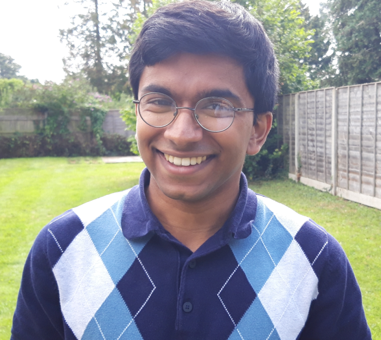 Junaid Hameed wearing blue diamond checked jumper outside