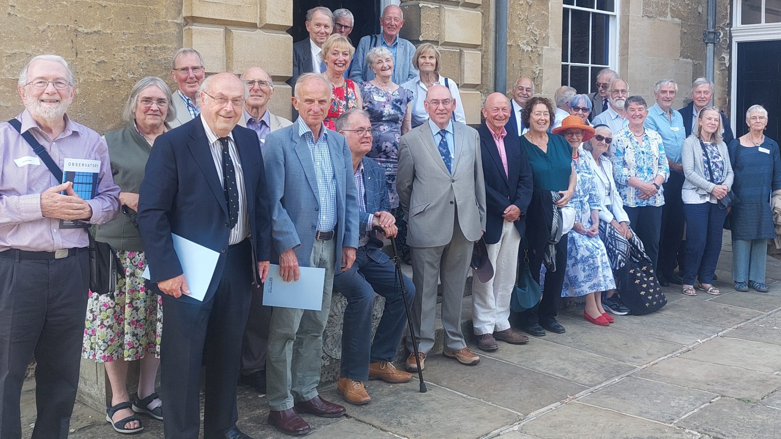 Group of mature individuals standing in front of old building