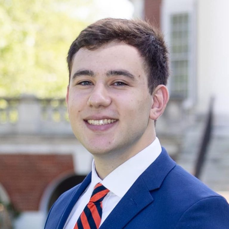 Grant Giangrasso profile pic smiling outside in jacket and tie