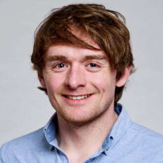 James Matthews Profile Pic In Open Neck Light Blue Shirt Smiling