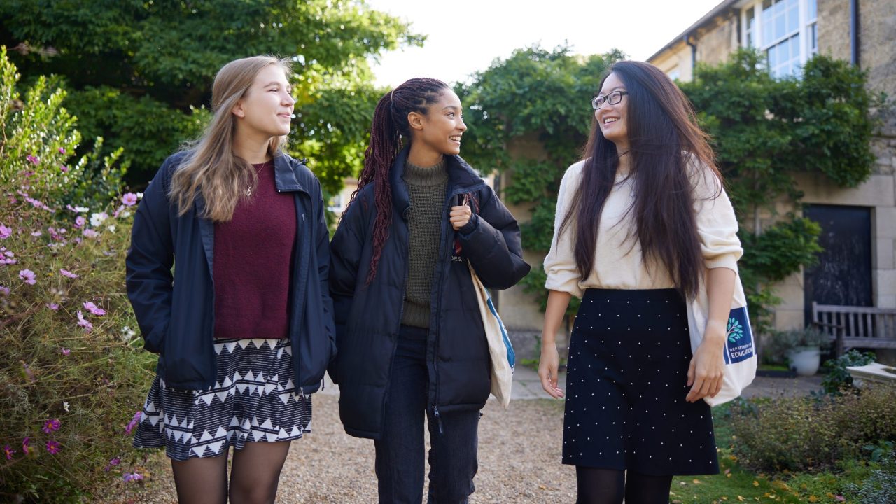 Three Students Walking Through Observatory Gardens Smiling
