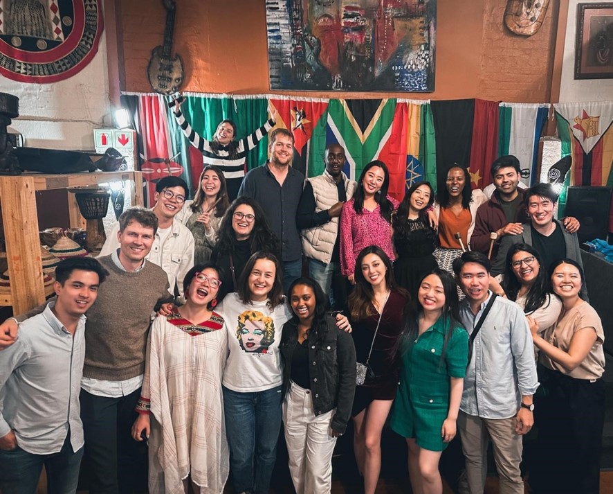 Thomas Gibson In Informal Group In Room Inside With Flags Behind