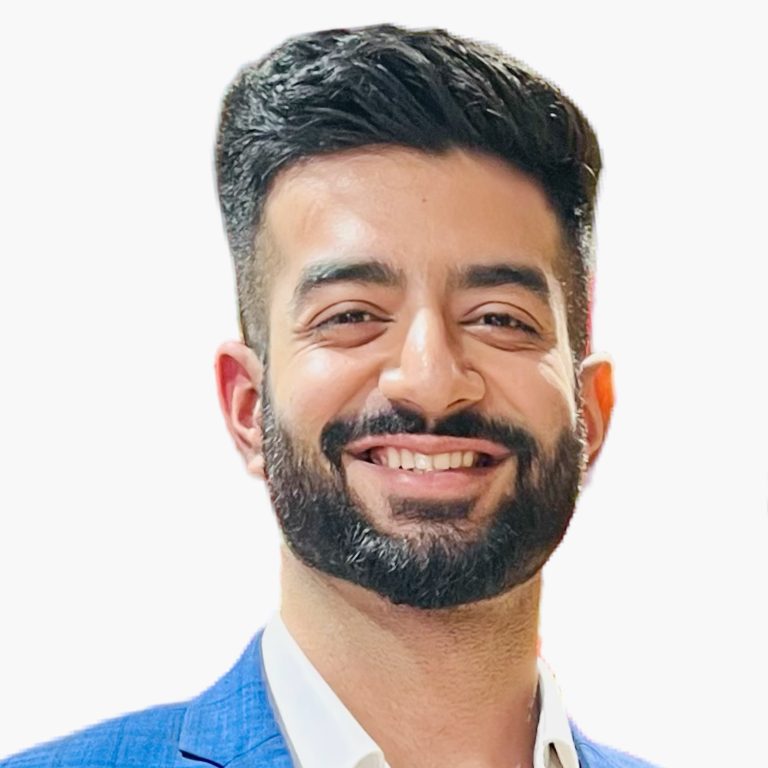 Ishan Nagpal in front of white background wearing blue suit