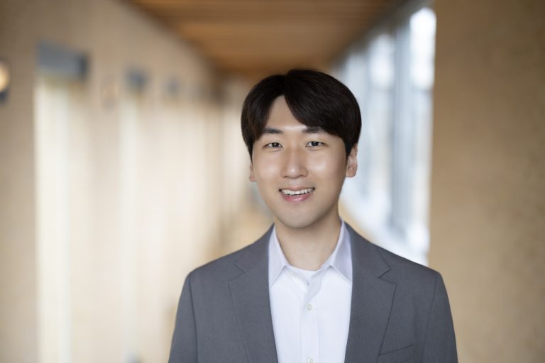 Kyeyoung Shin wearing grey suit and white shirt