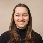 Charlotte Werndl headshot in front of brown wall