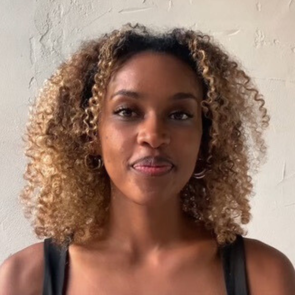 ElimShanko in front of white background Headshot