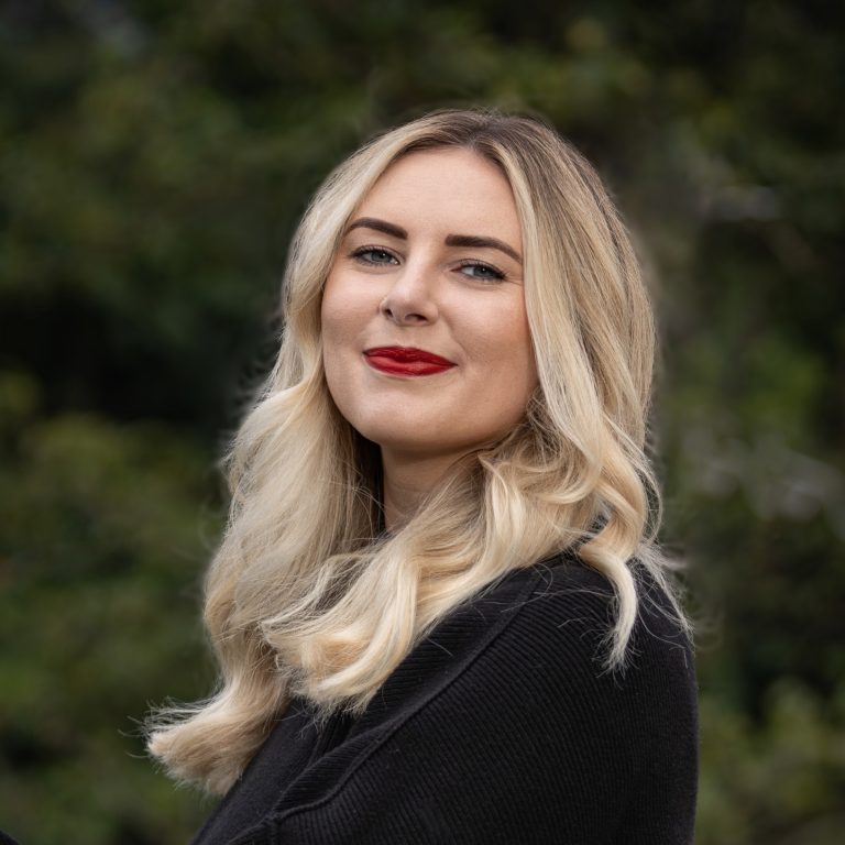 Malia Skjefte in front of greenery Headshot