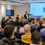 Lennard Lee gives a lecture in a crowded lecture theatre at Green Templeton College