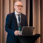 Charles Roehr Speaking Behind Lectern Square