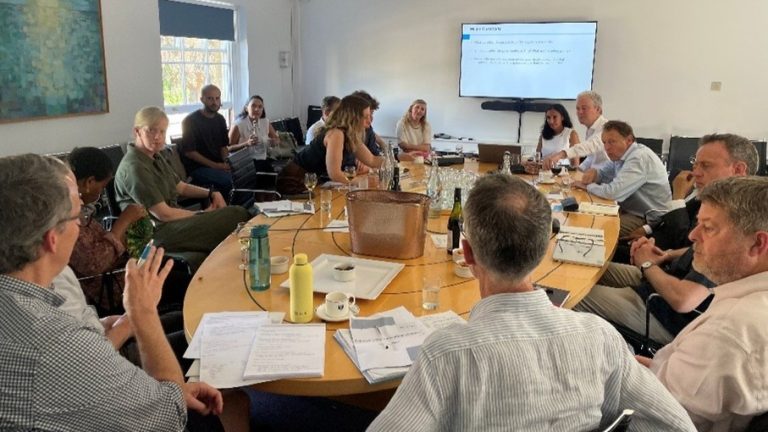 Philanthropy In The Humanitarian Sector round table discussion with screen behind