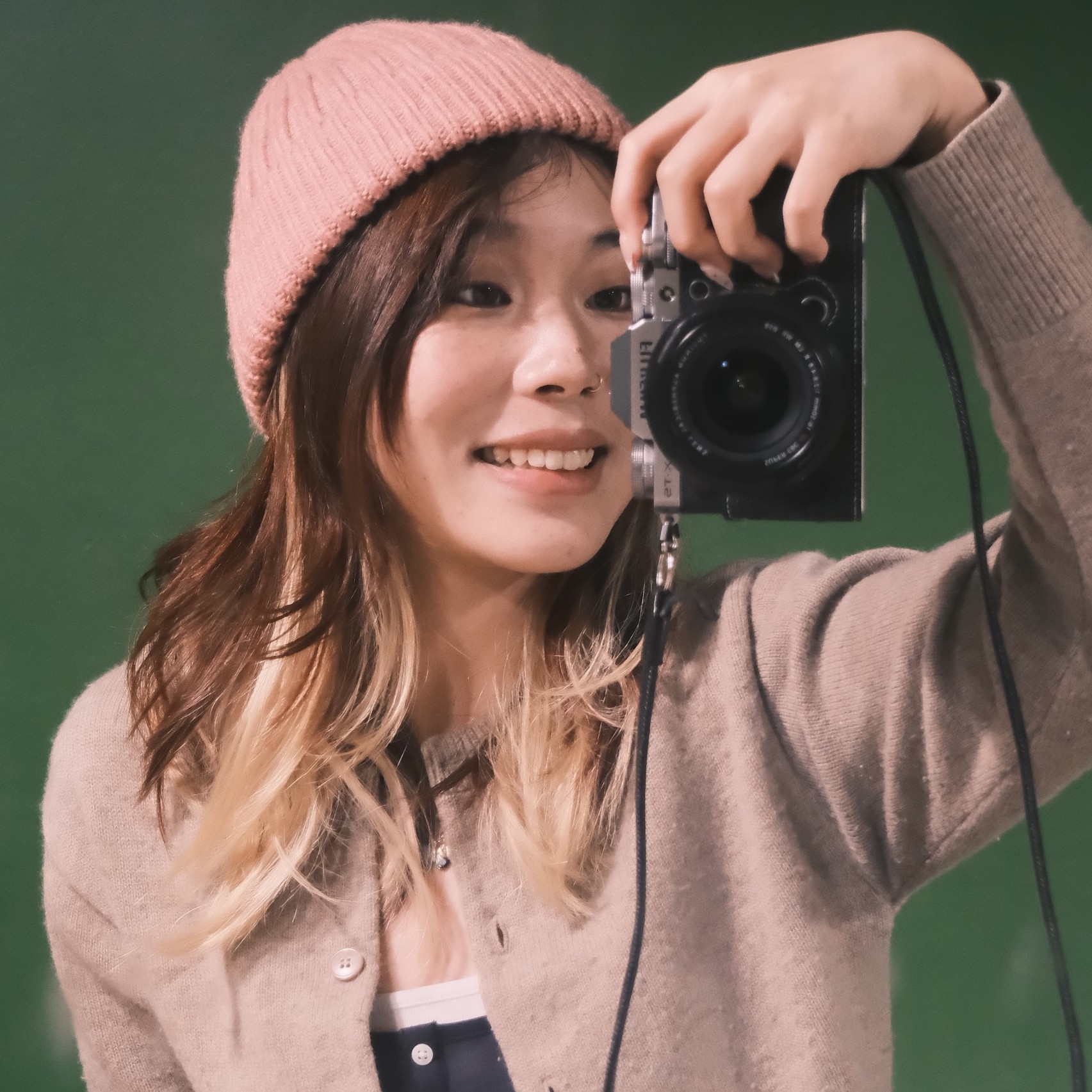 Duoduo Li Pictured Holding Camera