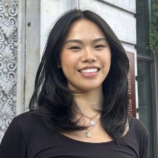 Profile pic: smiling outside building
